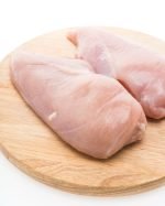 Raw fresh chicken meat on wooden cutting board isolated on white background